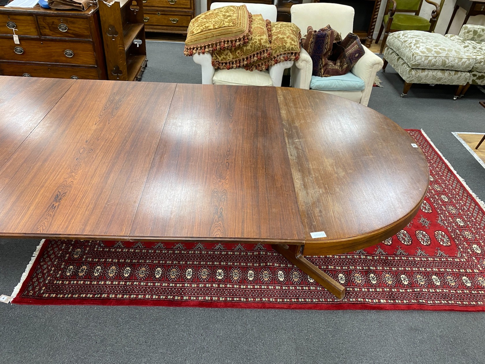 A mid century Danish design Indian rosewood extending dining table, 308cm extended, three spare leaves, width 129cm, height 72cm